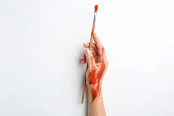 Artist's hand with brush on white background — Stock Photo, Image