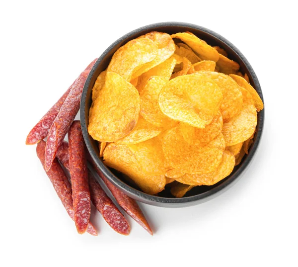 Bowl with tasty potato chips and smoked sausages on white background — Stock Photo, Image