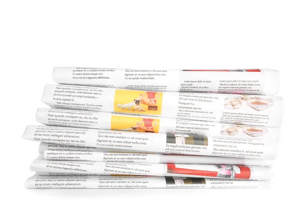 Many newspapers on table against white background — Stock Photo, Image