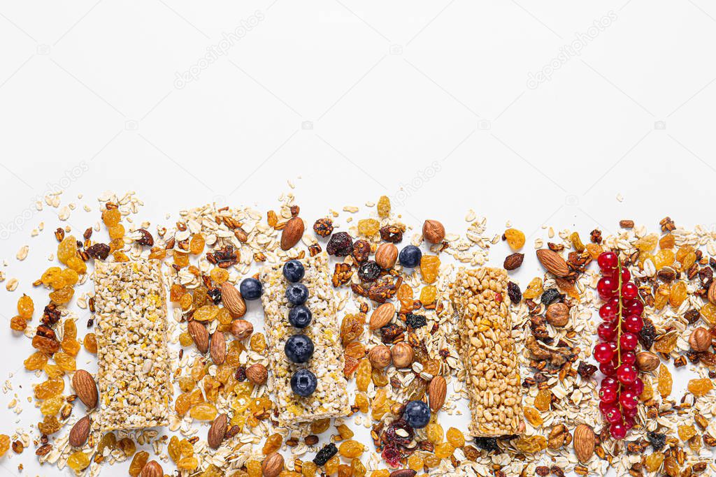 Tasty granola bars on white background