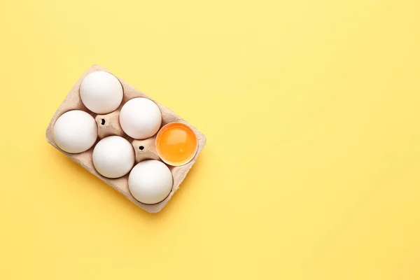 Box with fresh raw eggs on color background — 图库照片