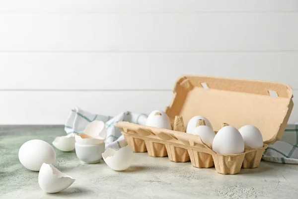 Box with fresh raw eggs on table — Stock Photo, Image