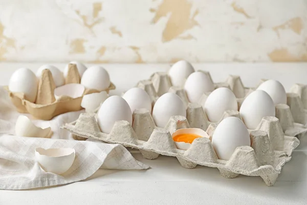 Box with fresh raw eggs on table — Stock Photo, Image