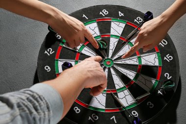 İnsanlar dart tahtasından dart oynuyorlar.