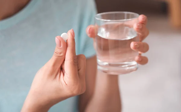 Young woman taking medicine, closeup — Stock Photo, Image