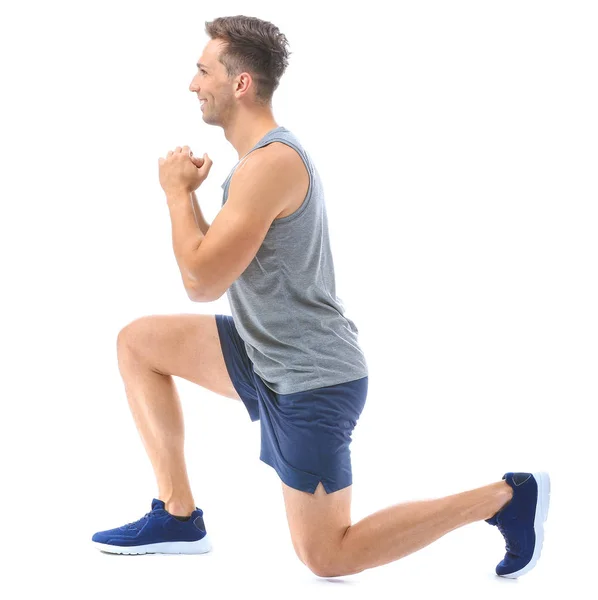 Sporty young man training against white background — Stock Photo, Image