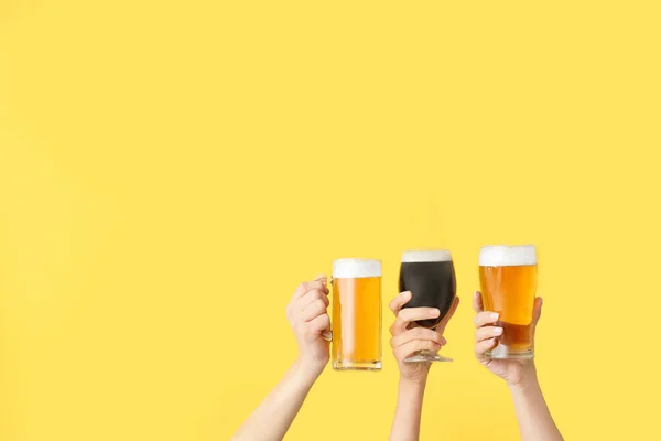 Hands with fresh beer on color background — Stock Photo, Image