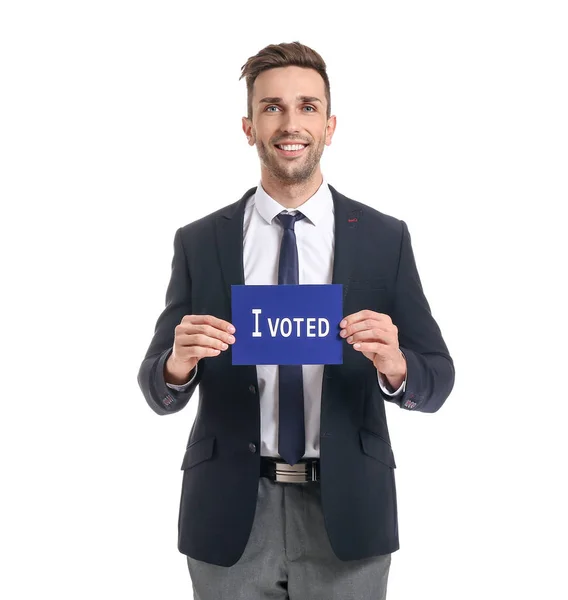 Businessman holding paper with text I VOTED on white background — Stock Photo, Image