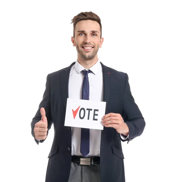 Businessman holding paper with text VOTE and showing thumb-up on white background — Stock Photo, Image