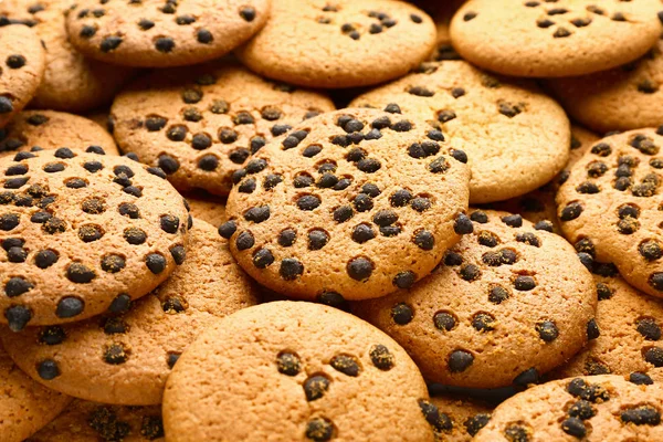 Many tasty cookies with chocolate chips as background — Stock Photo, Image