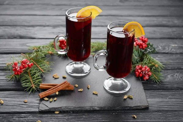 Glass cups of tasty mulled wine on wooden background — Stock Photo, Image