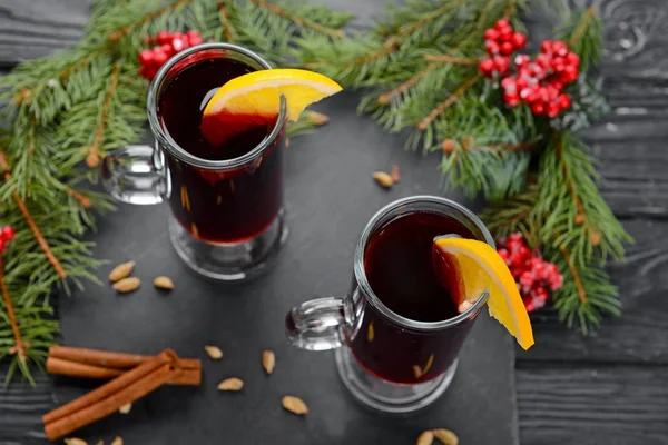 Glass cups of tasty mulled wine on wooden background — Stock Photo, Image