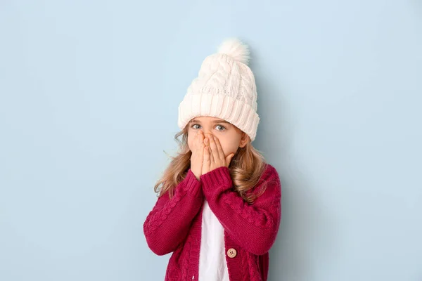 Cute girl in winter clothes on color background — Stock Photo, Image