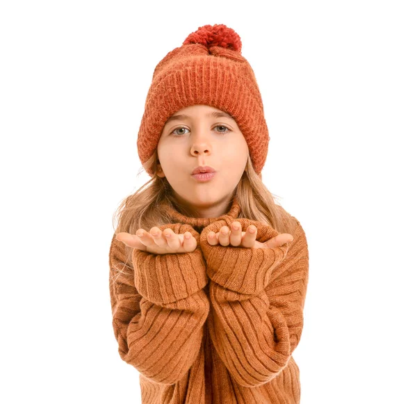 Cute little girl in winter clothes blowing kiss on white background — Stock Photo, Image