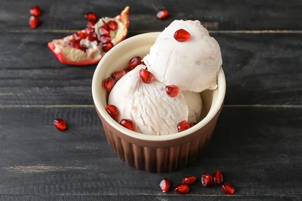 Bowl with tasty ice-cream and pomegranate on table — Stock Photo, Image