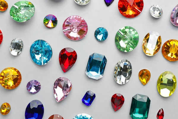 Different precious stones for jewellery on light background — Stock Photo, Image