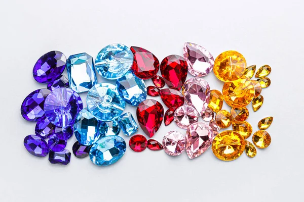 Different precious stones for jewellery on light background — Stockfoto