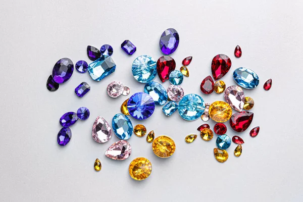 Different precious stones for jewellery on light background — Stockfoto