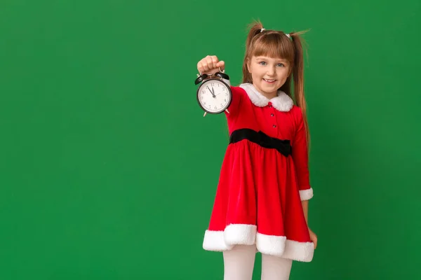 Little girl in Santa costume and with alarm clock on color background. Christmas countdown concept — Stock Photo, Image