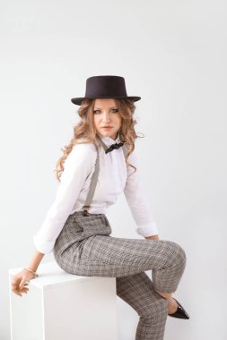 Aydınlık arka planda modaya uygun genç bir kadın.