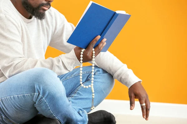 African-American Muslim man praying indoors