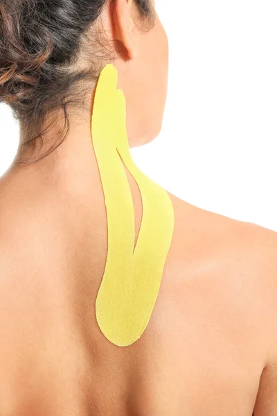 Sporty woman with physio tape applied on neck against white background, closeup — Stock Photo, Image