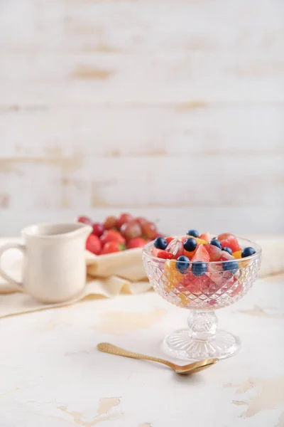 Glass bowl with tasty fruit salad on table — Stock Photo, Image