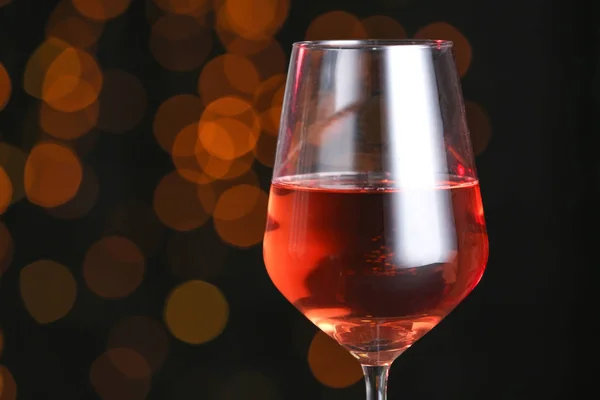 Glass of tasty wine on dark background — Stock Photo, Image