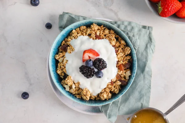 Tasty granola with yogurt in bowl on table — Stock Photo, Image