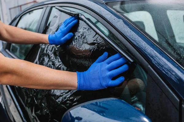Male worker tinting car window — Stock Photo, Image