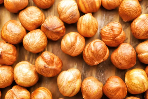 Many tasty hazelnuts as background — Stock Photo, Image