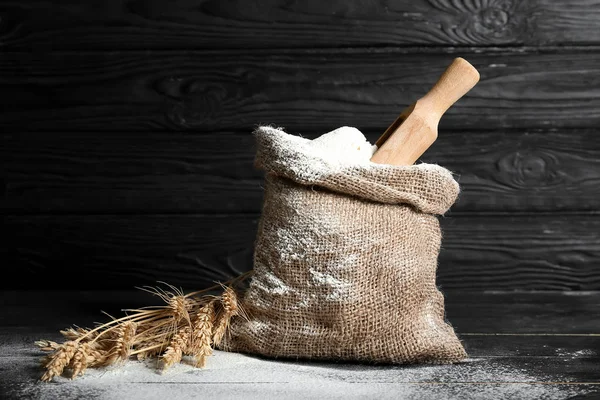 Bag with flour on dark background — Stock Photo, Image