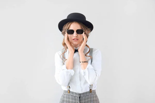 Fashionable young woman on light background — Stock Photo, Image