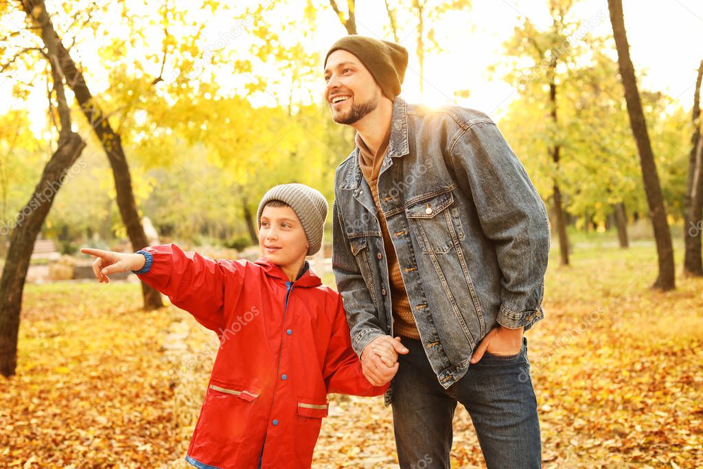 Happy father and son in autumn park