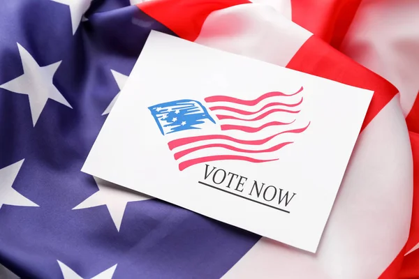 Paper with text VOTE NOW on USA flag — Stock Photo, Image