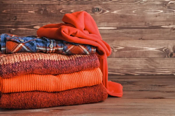 Stack of warm clothes on table