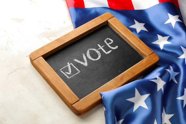 Chalkboard with text VOTE and USA flag on light background — Stock Photo, Image