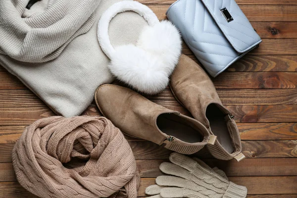 Stylish winter clothes on wooden background — Stock Photo, Image