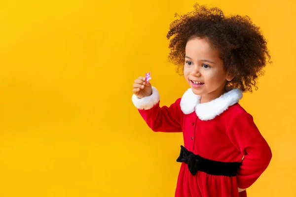 Little African-American girl in Santa costume on color background — Stock Photo, Image