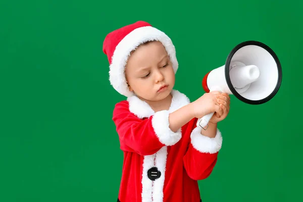 Cute little boy in Santa costume and with megaphone on color background — Stock Photo, Image