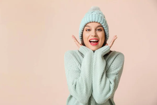 Happy young woman in winter clothes on light background — Stock Photo, Image