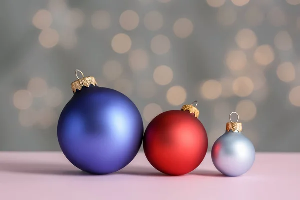 Beautiful Christmas balls on table against blurred lights — Stock Photo, Image