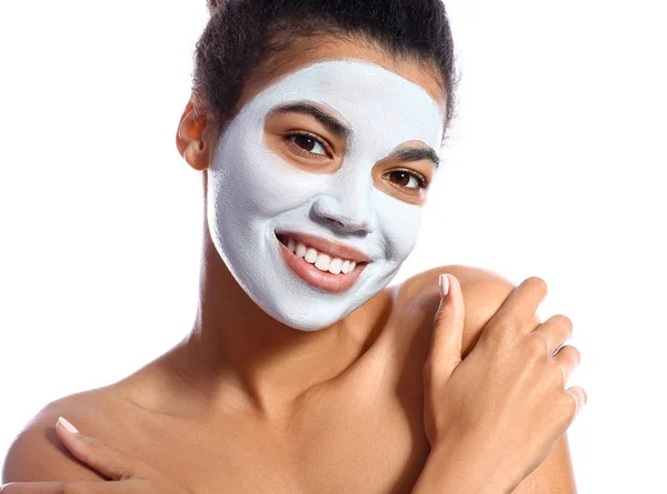 Beautiful African-American woman with facial mask on white background — Stock Photo, Image