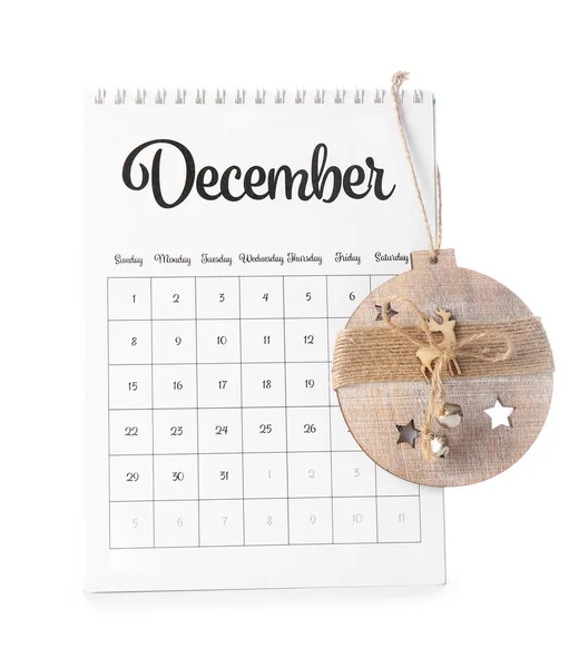 Calendar with page of December and Christmas decor on white background — Stock Photo, Image