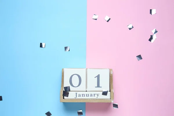 Calendar with date of New Year on color background — Stock Photo, Image