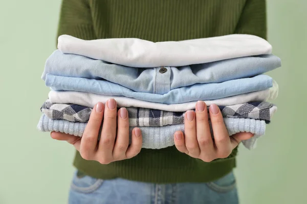 Young woman with clean clothes on color background, closeup — Stock Photo, Image