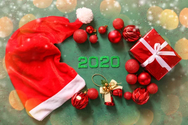 图为2020年圣诞老人帽、装饰品和彩色背景礼物 — 图库照片