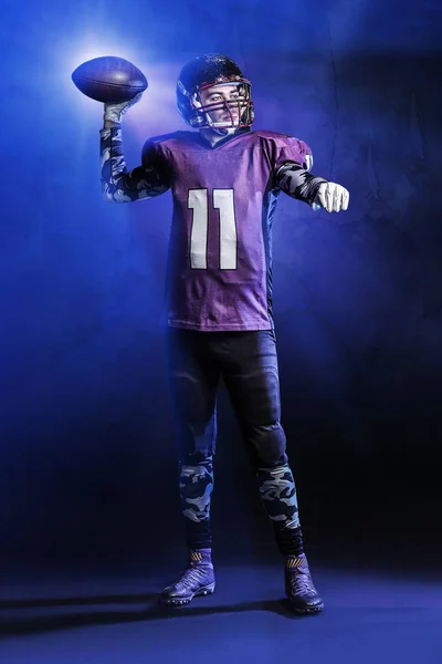 American football player on dark background — Stock Photo, Image