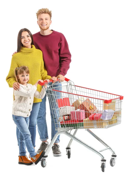 Family with shopping cart full of Christmas gifts on white background — Stock Photo, Image