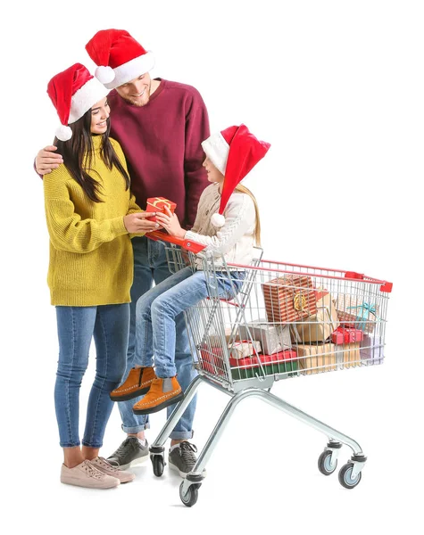 Family with shopping cart full of Christmas gifts on white background — Stock Photo, Image